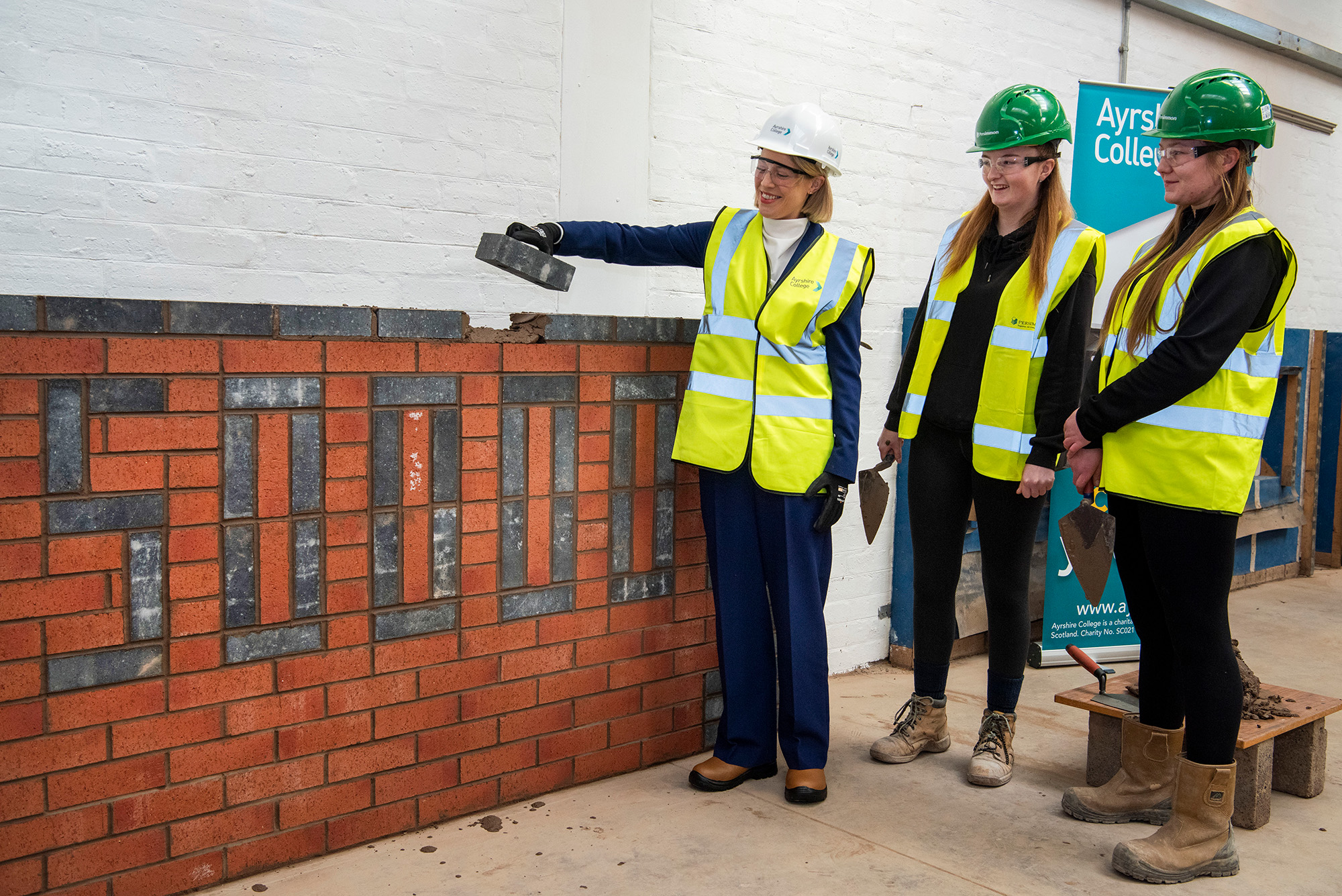 Cabinet secretary college visit marks Persimmon's 50,000th brick donation